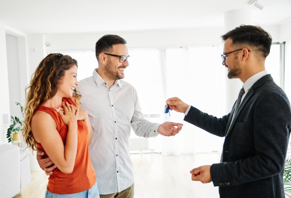 Couple receiving keys to new house